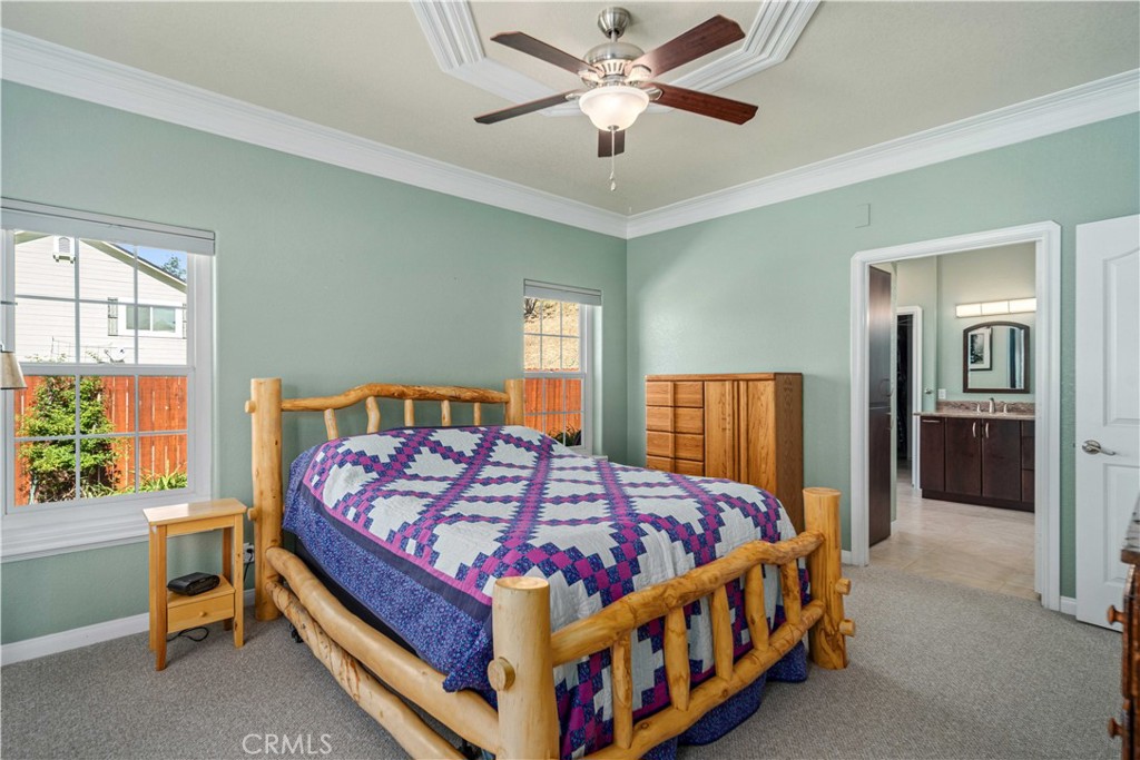 9251 Elizabeth Lake Road Leona Valley, CA 93551 - Photo 22 of 53 a bedroom with a bed and a chandelier