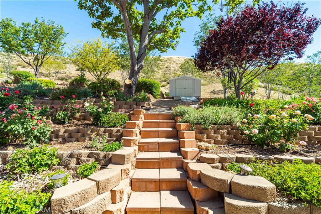 9251 Elizabeth Lake Road Leona Valley, CA 93551 - Photo 28 of 53 a view of a chairs and table in a backyard