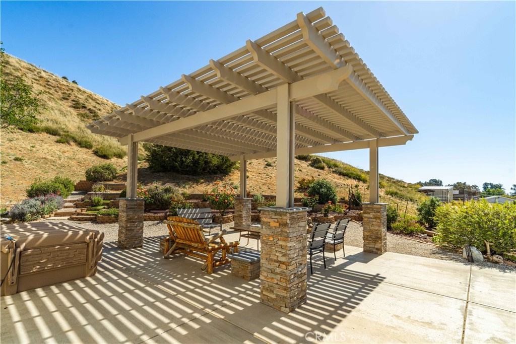 9251 Elizabeth Lake Road Leona Valley, CA 93551 - Photo 32 of 53 a view of a patio with table and chairs under an umbrella