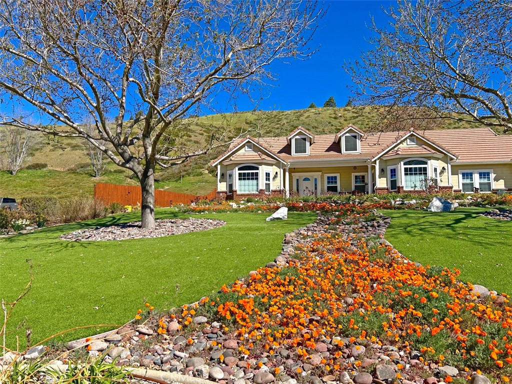 9251 Elizabeth Lake Road Leona Valley, CA 93551 - Photo 4 of 53 a front view of a house with a garden