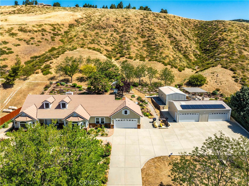 9251 Elizabeth Lake Road Leona Valley, CA 93551 - Photo 48 of 53 a view of a white house with a yard