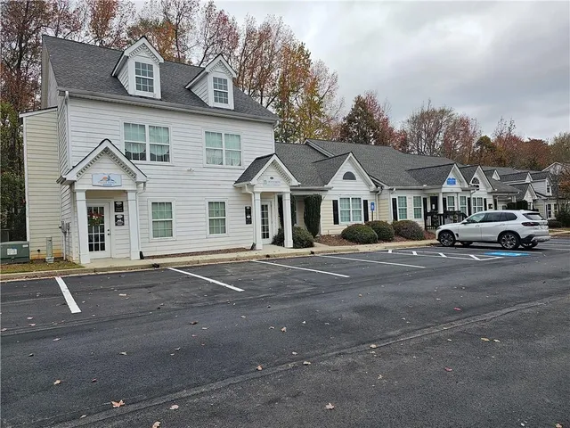 a front view of a house with a road