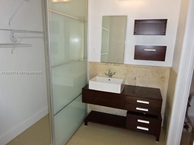 9727 Hammocks Boulevard, Unit 101D Miami, FL 33196 - Photo 10 of 12 a bathroom with a sink and a mirror