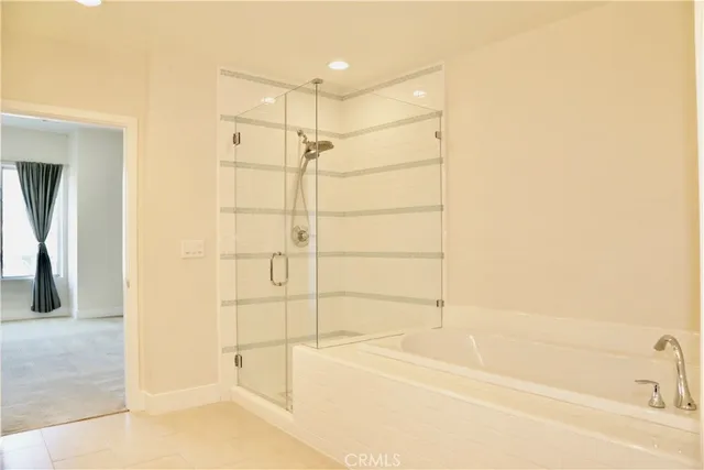 a bathroom with a bathtub and a shower