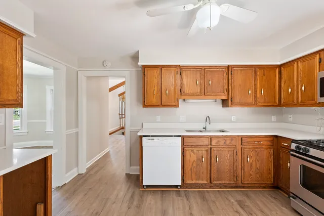 a kitchen with a sink stove top oven and cabinets