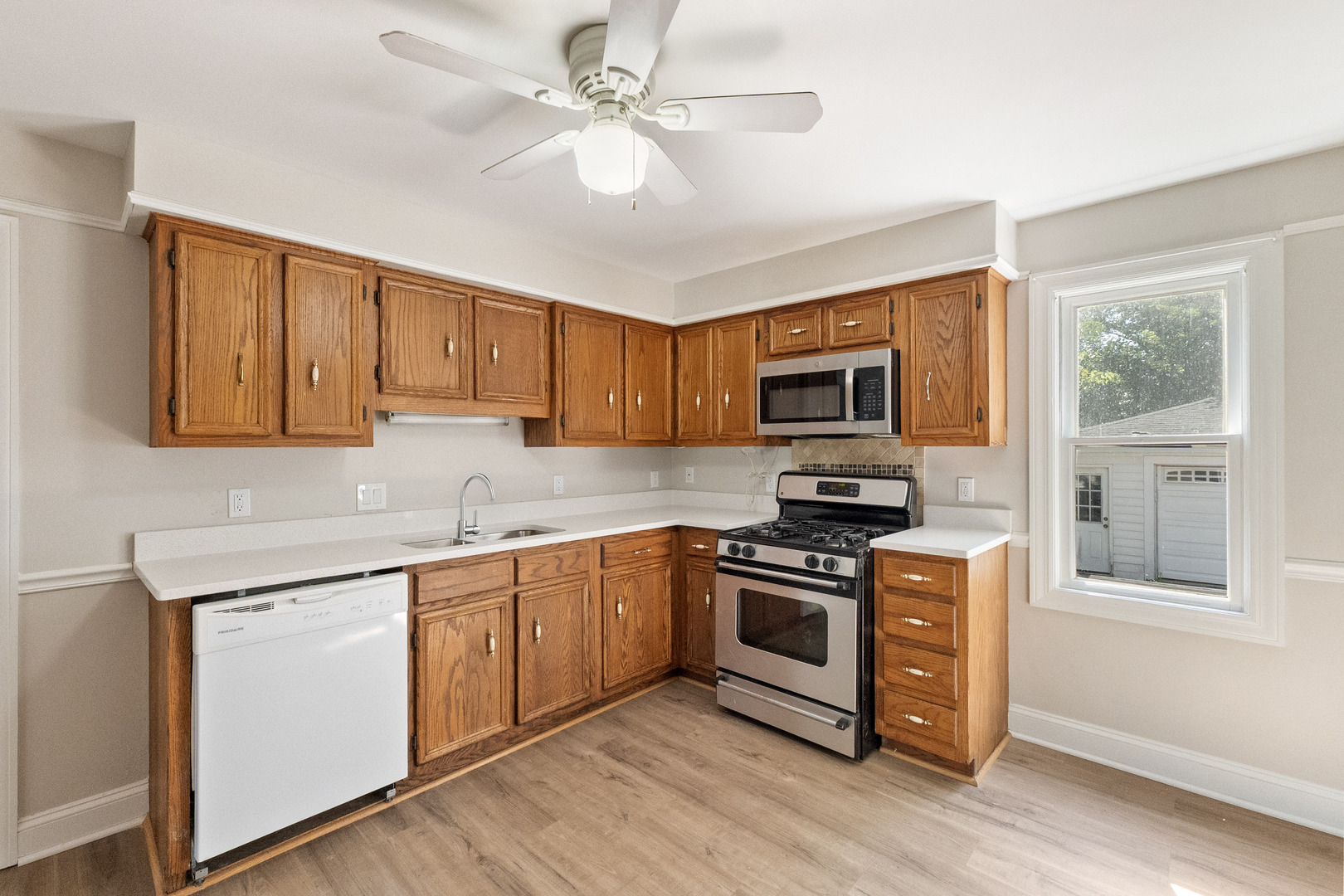 129 South Prairie Street Batavia, IL 60510 - Photo 15 of 45 a kitchen with stainless steel appliances granite countertop a stove top oven a sink dishwasher a dining table and chairs with wooden floor