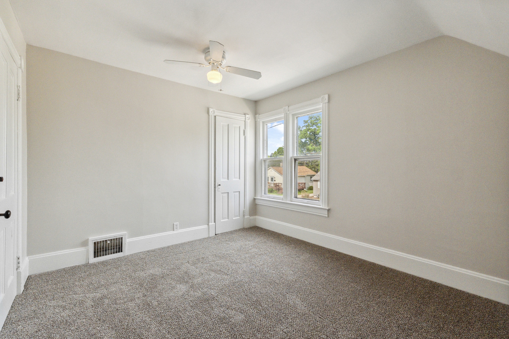 129 South Prairie Street Batavia, IL 60510 - Photo 27 of 45 an empty room with windows and chandelier fan