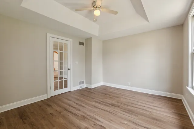 wooden floor in an empty room with a window
