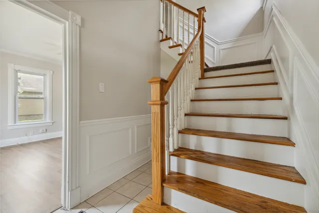 a view of entryway with wooden floor and stairs
