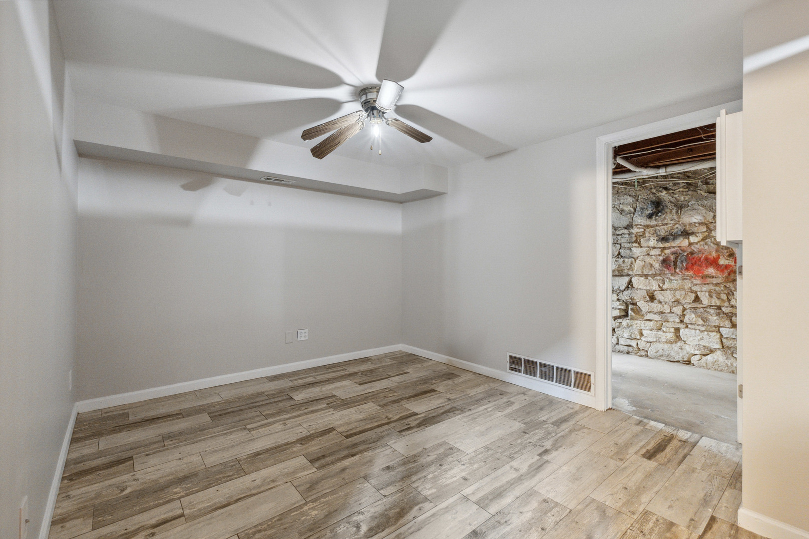 129 South Prairie Street Batavia, IL 60510 - Photo 34 of 45 a view of a room with wooden floor and fan in a room