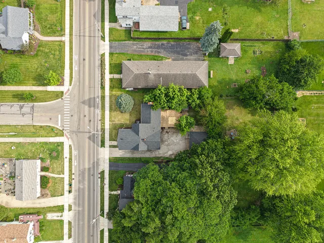 an aerial view of a house with a yard