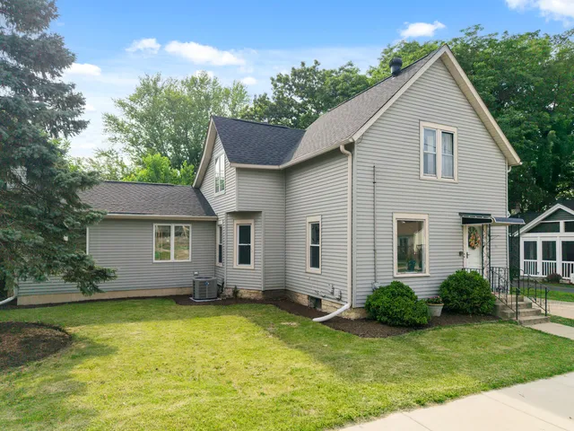 a view of a house with a yard patio and fire pit