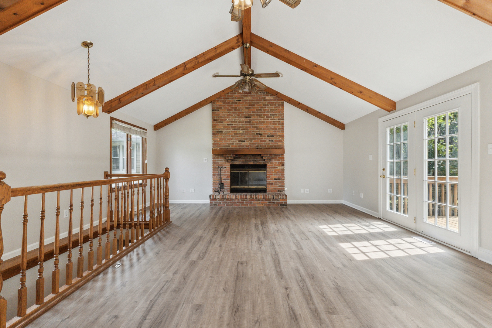 129 South Prairie Street Batavia, IL 60510 - Photo 5 of 45 a view of empty room with wooden floor and fireplace