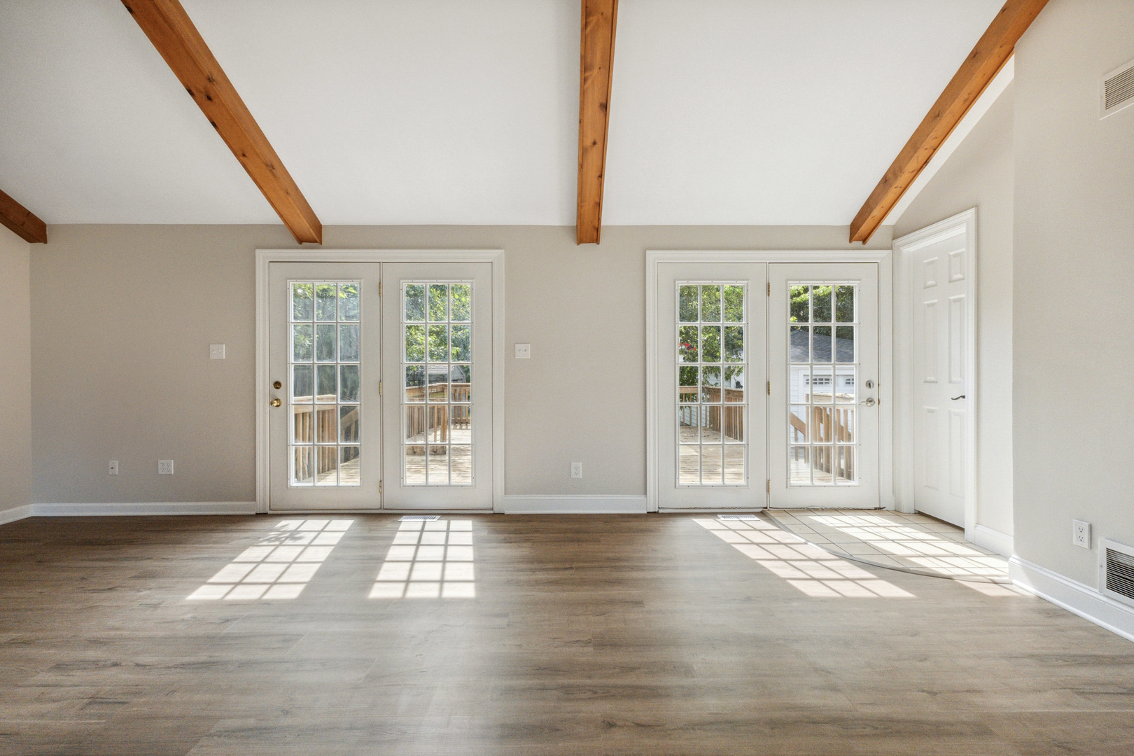 129 South Prairie Street Batavia, IL 60510 - Photo 8 of 45 a view of an empty room with wooden floor and a window