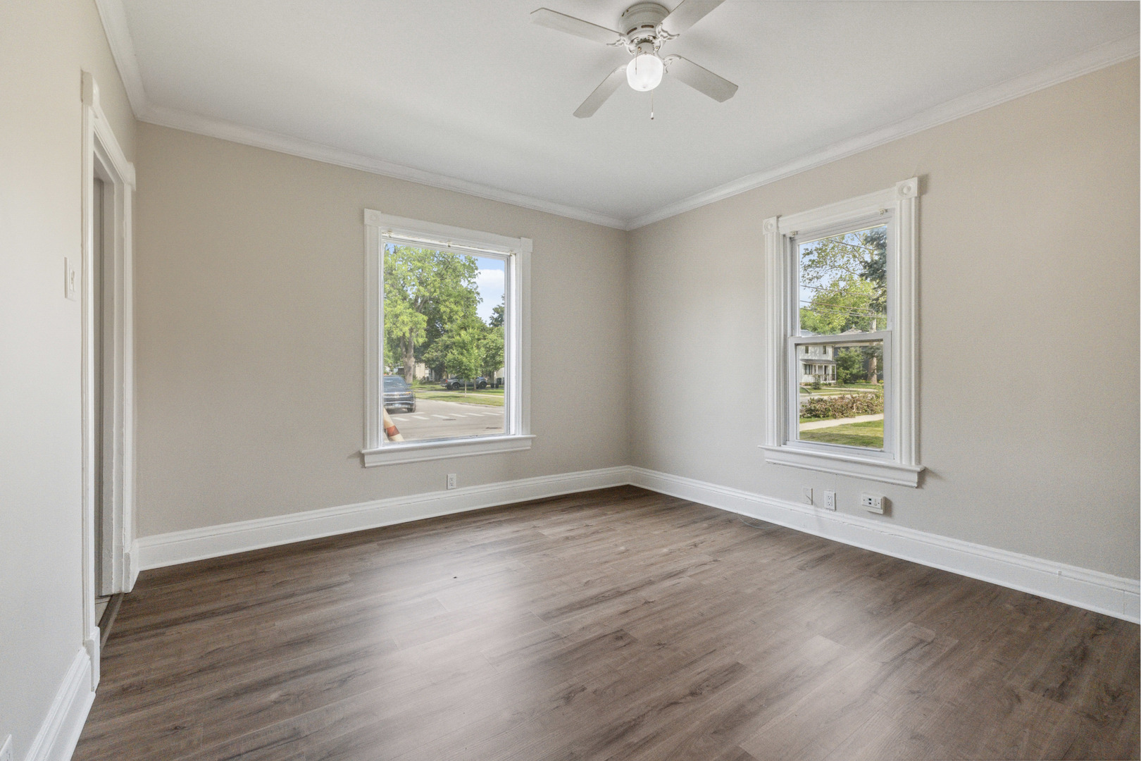 129 South Prairie Street Batavia, IL 60510 - Photo 9 of 45 a view of an empty room with wooden floor and window
