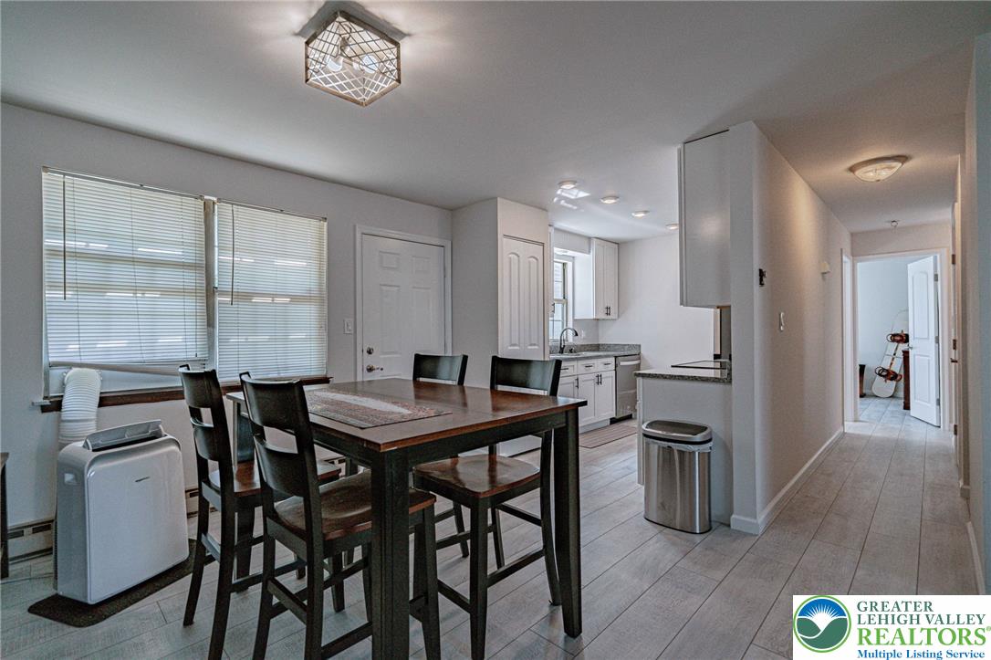 25 North 8th Street Emmaus, PA 18049 - Photo 51 of 51 An open floor plan seamlessly connects the kitchen and dining areas, with light wood flooring throughout.