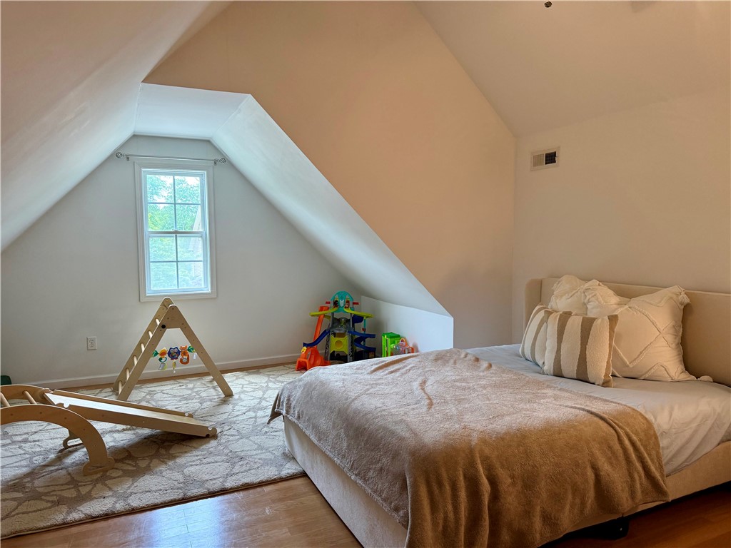 123 Abigail Lane Anderson, SC 29621 - Photo 15 of 22 This cozy bonus/bedroom features a unique sloped ceiling design and hardwood flooring.
