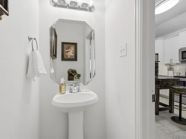 a kitchen with stainless steel appliances granite countertop a sink stove oven and white cabinets
