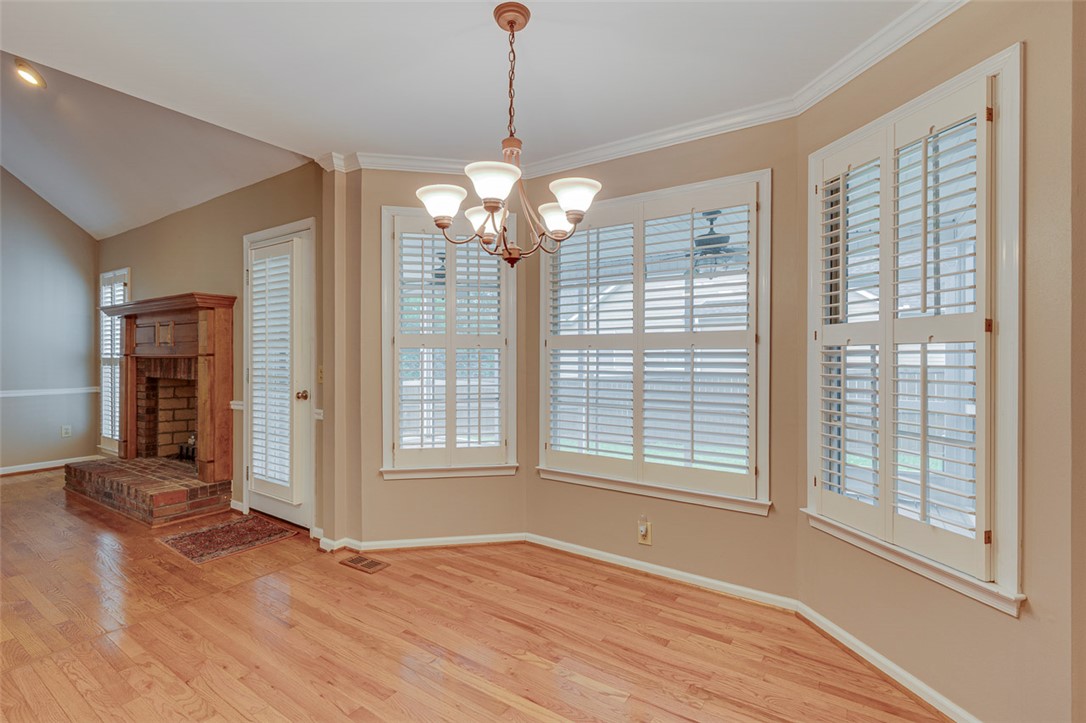 302 Wild Rice Drive Simpsonville, SC 29681 - Photo 10 of 44 Polished hardwood floors and elegant crown molding frame this versatile sunlit dining space.