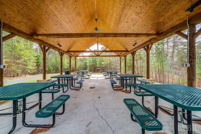 a view of a patio with table and chairs potted plants with large tree