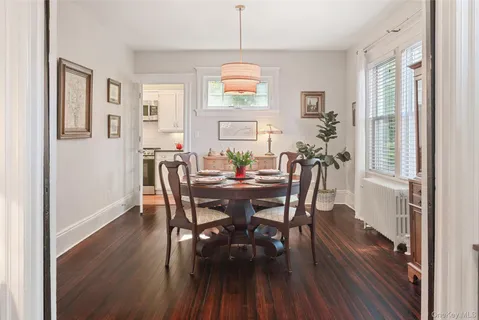 a kitchen with stainless steel appliances granite countertop a stove a sink and white cabinets