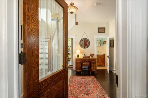 a living room with furniture fireplace and wooden floor
