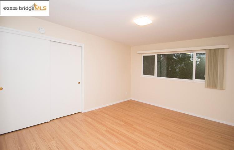 2636 Warring Street, Unit 104 Berkeley, CA 94704 - Photo 2 of 8 a view of a big room with wooden floor and windows