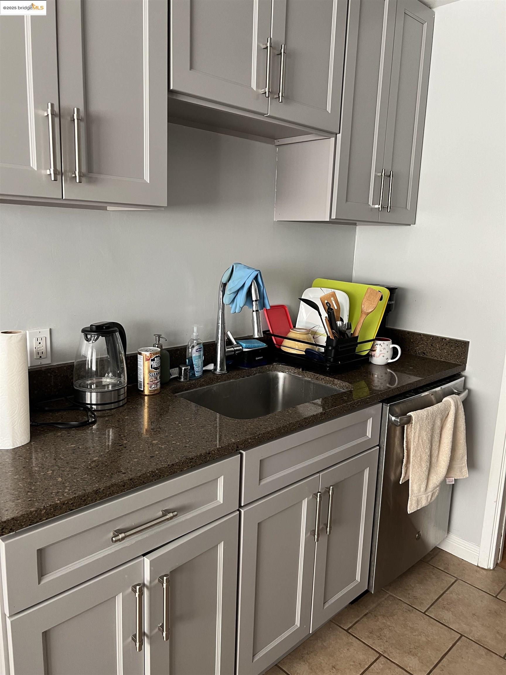 2636 Warring Street, Unit 104 Berkeley, CA 94704 - Photo 8 of 8 a kitchen with white cabinets and a sink