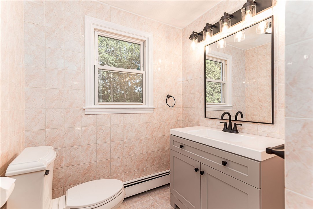 680 Fletcher Road North Kingstown, RI 02852 - Photo 19 of 41 Half bath on the first floor with tiled walls and floor