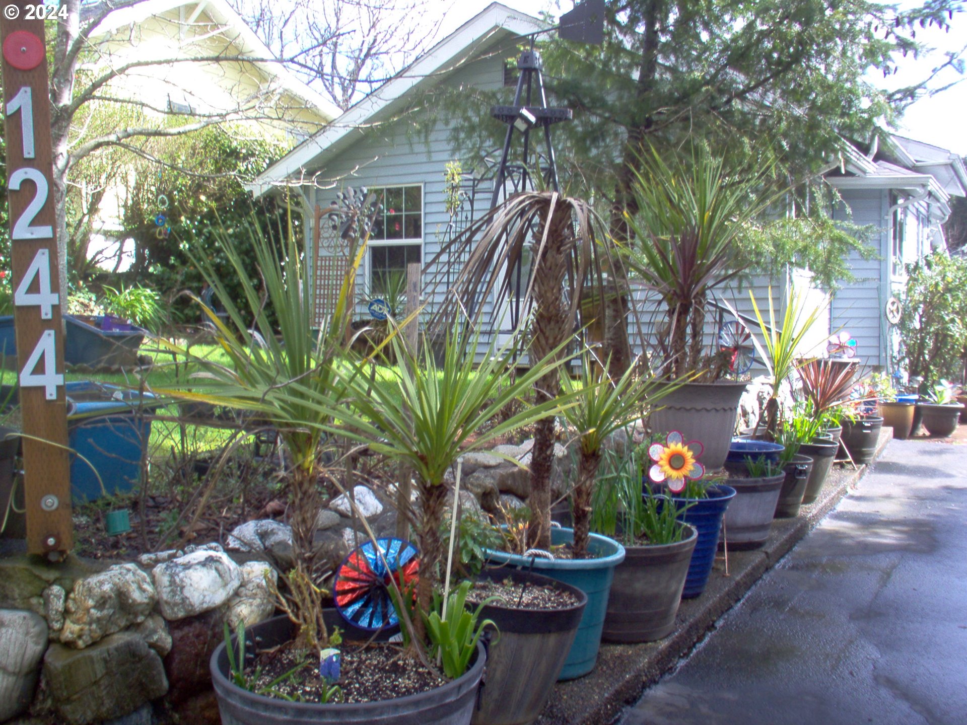 a front view of a house with a yard and a garden