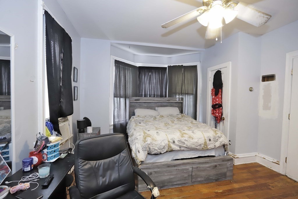 934 Middle Street Fall River, MA 02721 - Photo 17 of 30 a bedroom with a bed and a chandelier