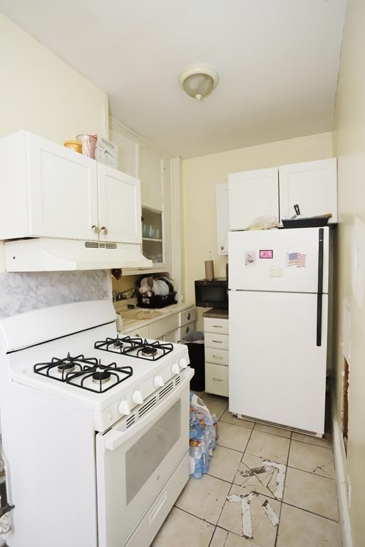 934 Middle Street Fall River, MA 02721 - Photo 19 of 30 a kitchen with a stove and a refrigerator