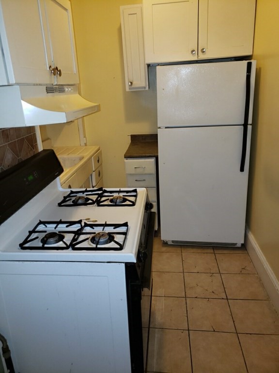 934 Middle Street Fall River, MA 02721 - Photo 29 of 30 a stove top oven sitting inside of a kitchen