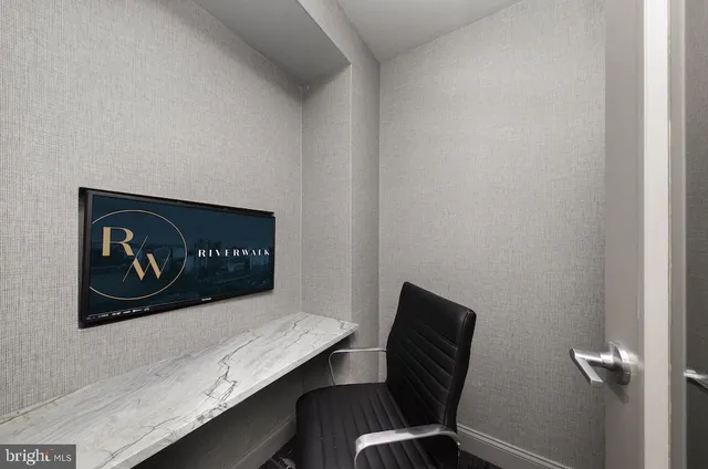 a view of a hallway with furniture and wooden floor