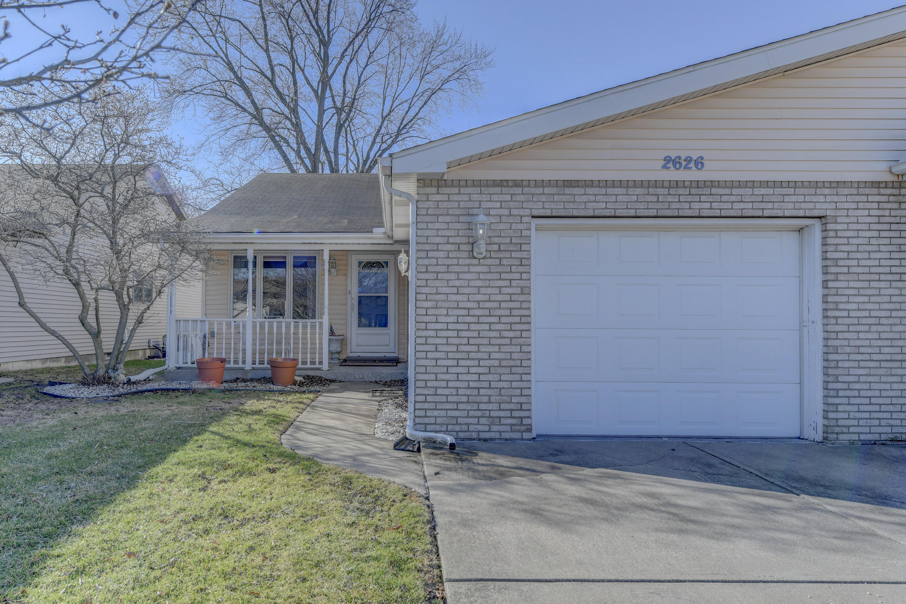 2626 41st Place Highland, IN 46322 - Photo 16 of 24 a front view of a house with a yard and garage