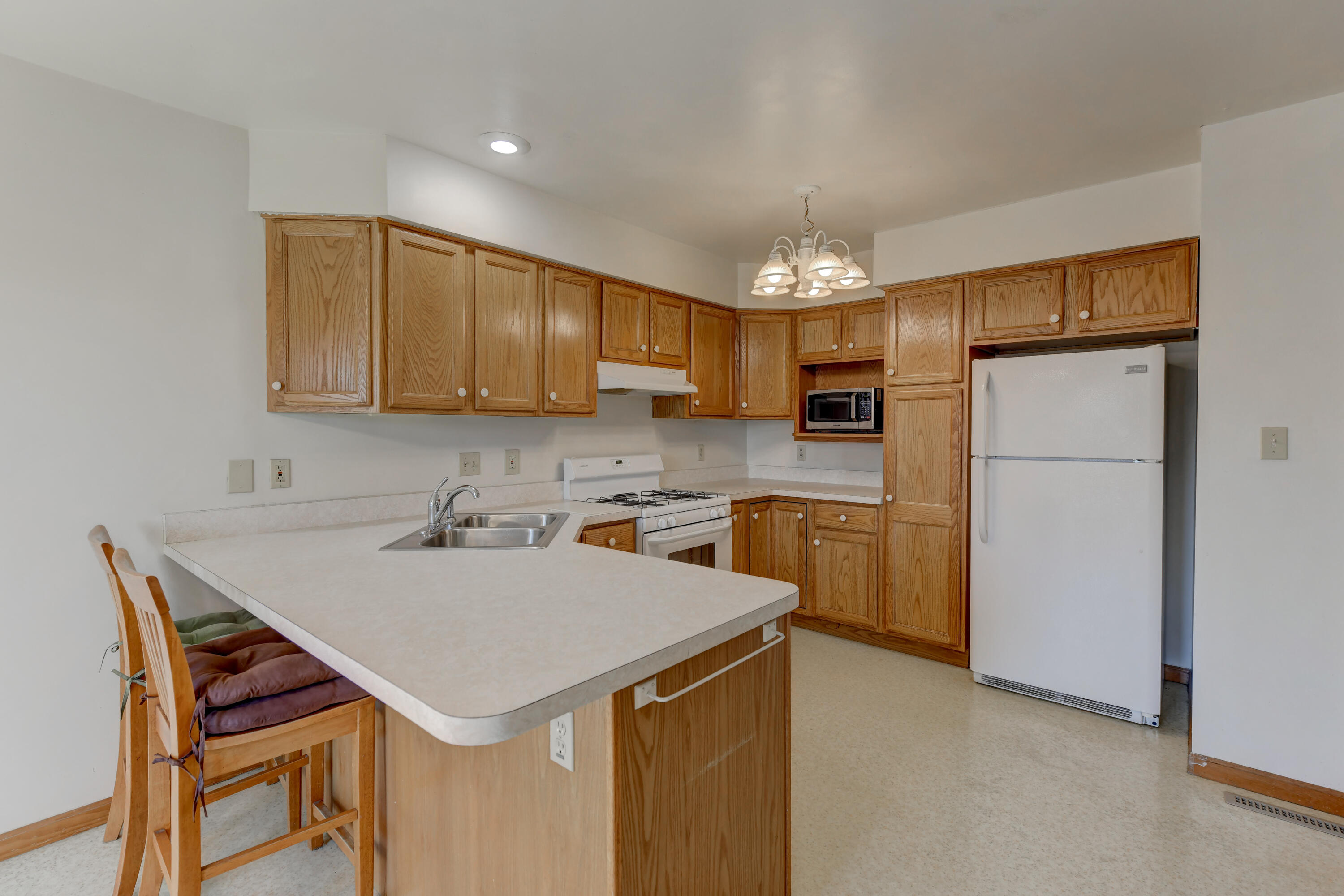 2626 41st Place Highland, IN 46322 - Photo 21 of 24 a kitchen with a refrigerator a stove a sink and a refrigerator