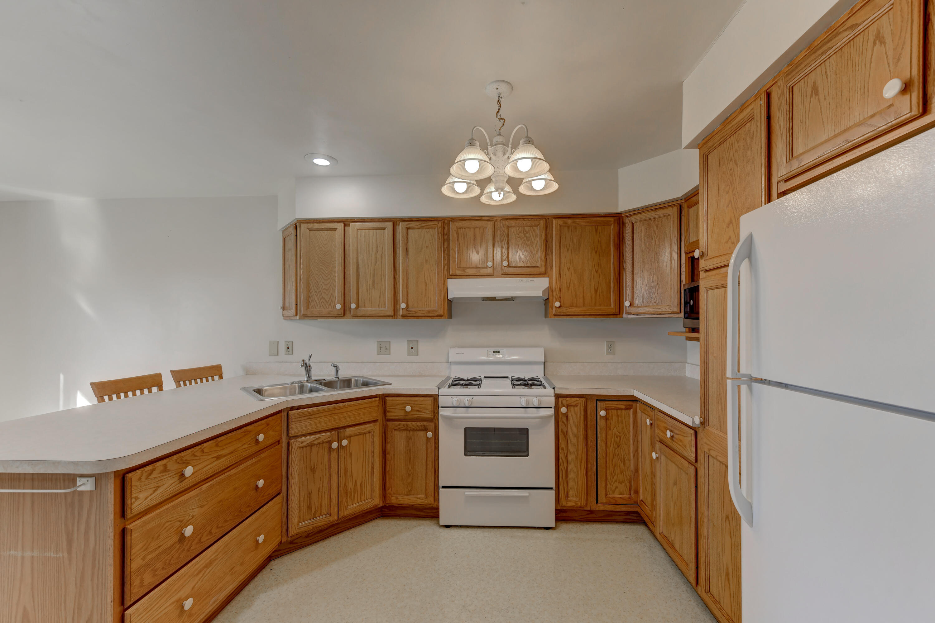 2626 41st Place Highland, IN 46322 - Photo 23 of 24 a kitchen with a sink a stove cabinets and refrigerator