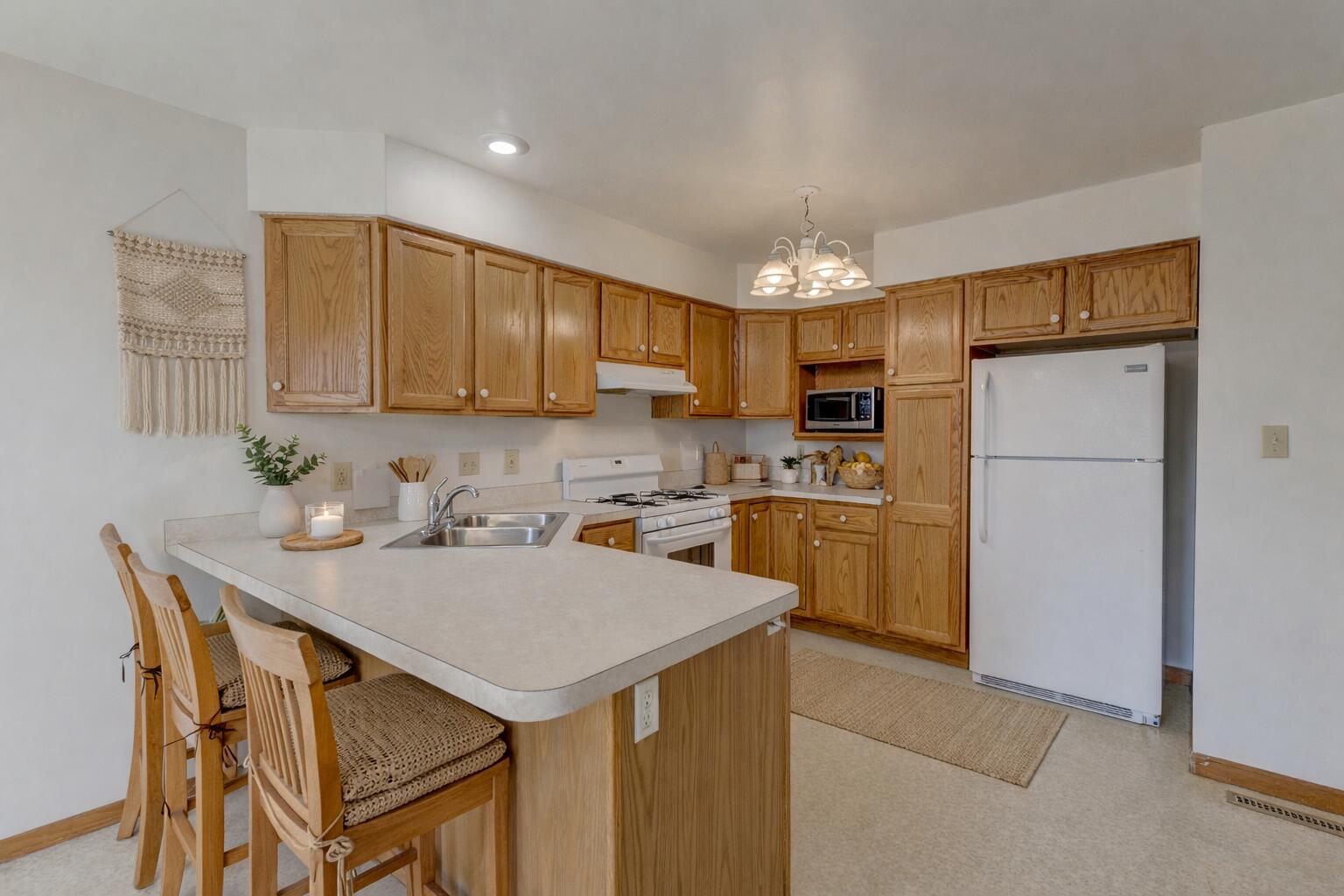 2626 41st Place Highland, IN 46322 - Photo 9 of 24 a kitchen with a sink a kitchen island and stainless steel appliances