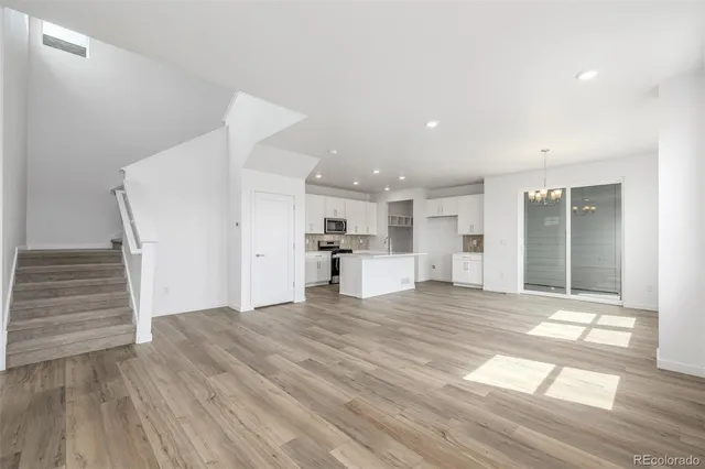 a view of a kitchen with wooden floor and a sink