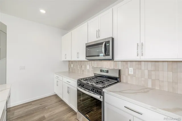 a kitchen with a sink stove and microwave