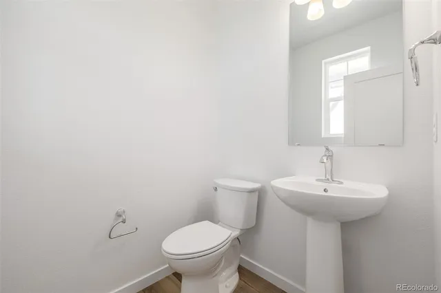 a bathroom with a sink a toilet and mirror