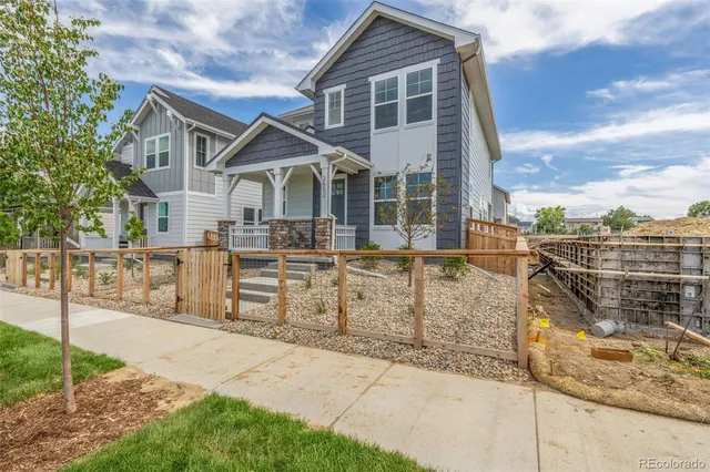 a view of a house with wooden fence
