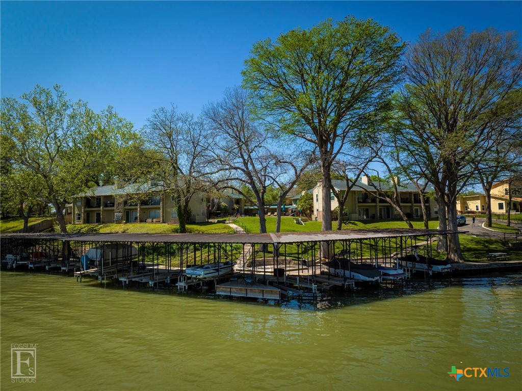 551 Terminal Loop Road, Unit B3 McQueeney, TX 78123 - Photo 1 of 41 a view of a house with swimming pool next to a lake view