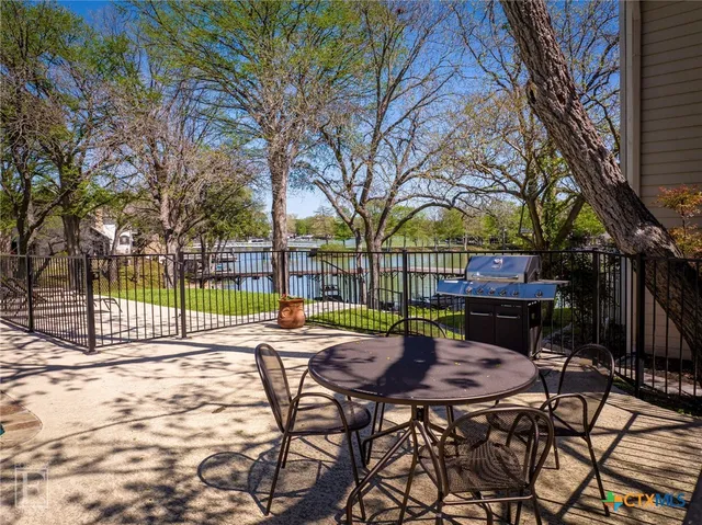 a view of a swimming pool with a patio and a yard