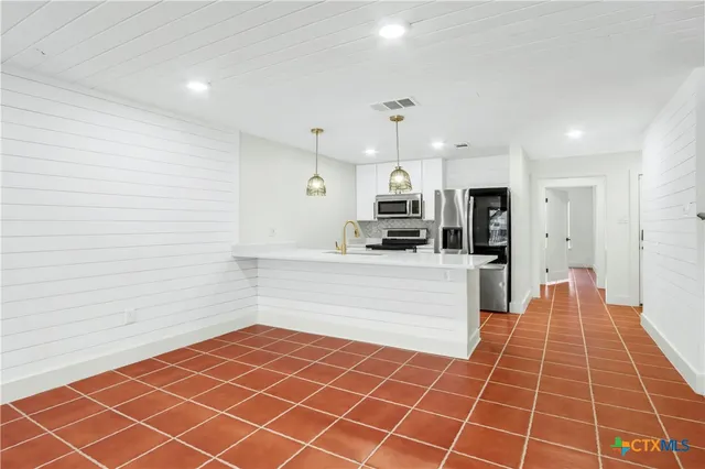 an empty room with wooden floor