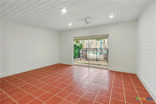 a view of an empty room with a window