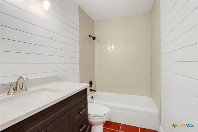 a bedroom with a bed and a fan