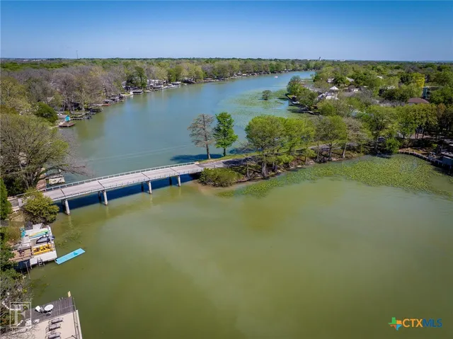 an aerial view of a houses with a lake view