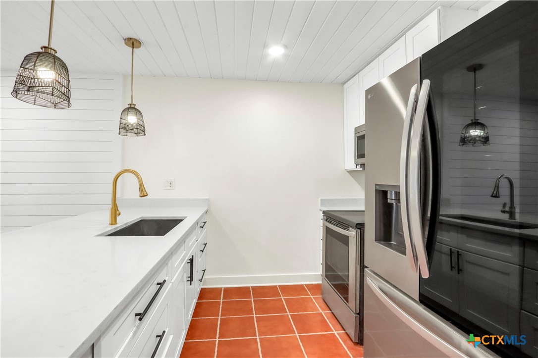551 Terminal Loop Road, Unit B3 McQueeney, TX 78123 - Photo 5 of 41 a kitchen with stainless steel appliances granite countertop a sink and a refrigerator