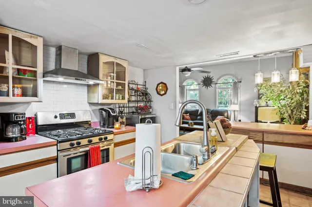 a kitchen with stainless steel appliances granite countertop a stove and a sink